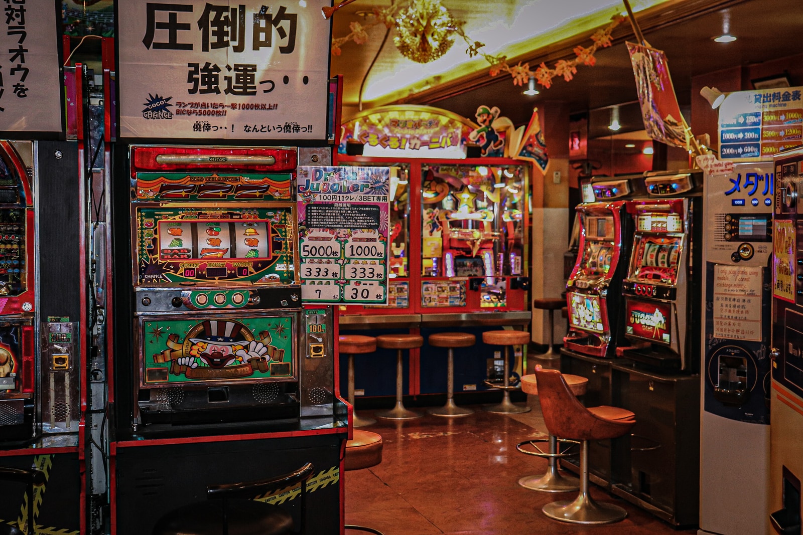 การแข่งขันสล็อตแมชชีน: จะเข้าร่วมได้อย่างไร? 3 arcade machine near brown wooden chair