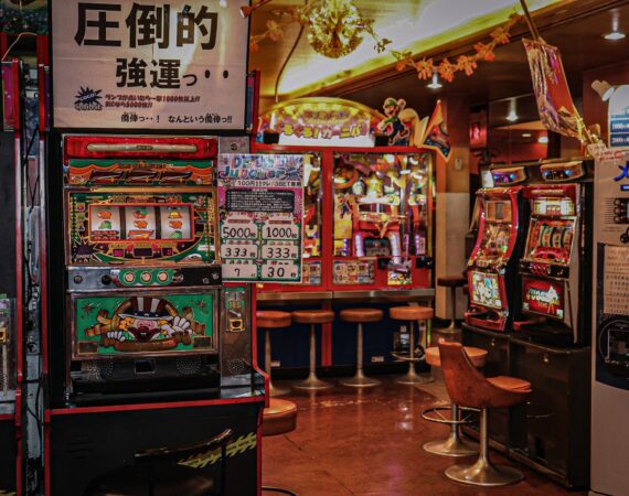 arcade machine near brown wooden chair